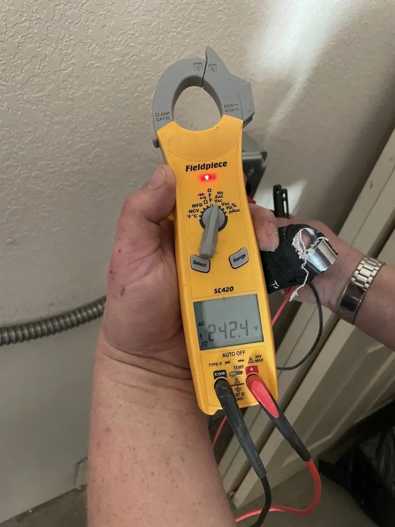 Voltage testing with clamp meter during Outlet Installation in Snowflake
